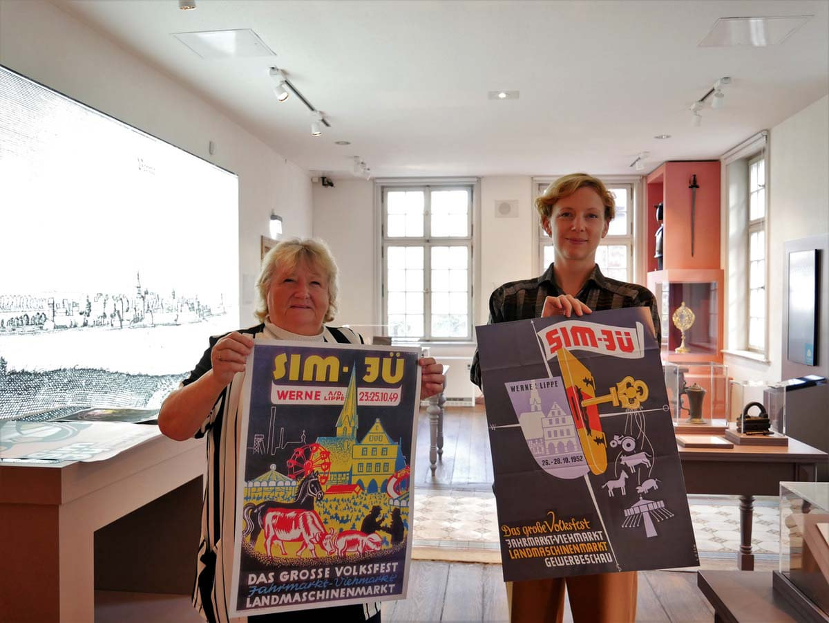 Nachdrucke von Sim-Jü-Plakaten von Karl Losch sind im Museum zu haben, kündigen Heidelore Fertig-Möller (links) und Dr. Constanze Döhrer an. Foto: Gaby Brüggemann