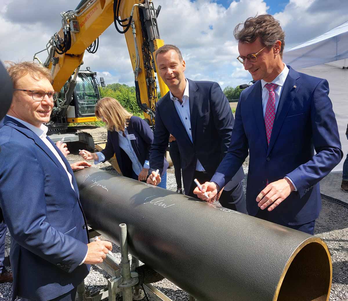 NRW-Ministerpräsident Hendrik Wüst (rechts), Bürgermeister Lothar Christ (links) und Dr. Thomas Hüwener von der OGE-Geschäftsführung verewigten sich beim 